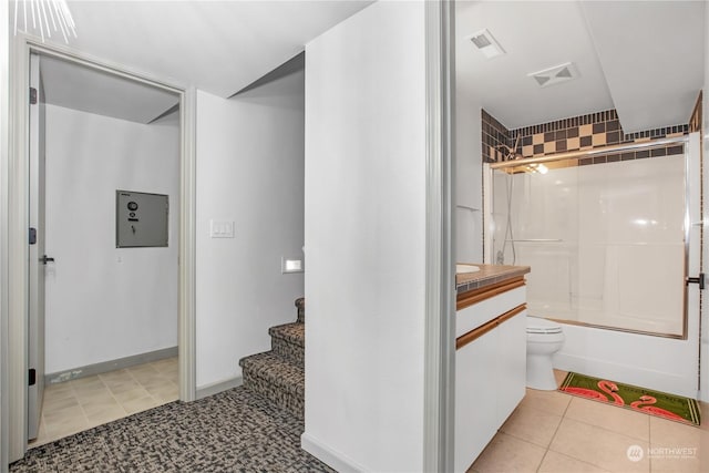 full bathroom featuring vanity, tile patterned flooring, enclosed tub / shower combo, and toilet