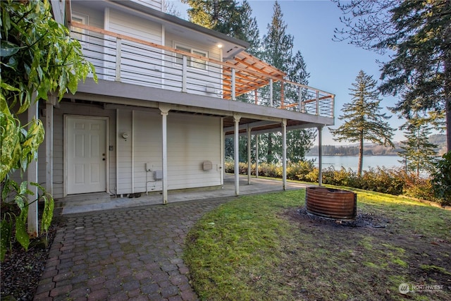 view of yard featuring a patio and a water view