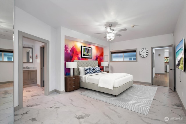 bedroom featuring sink, ensuite bath, and ceiling fan