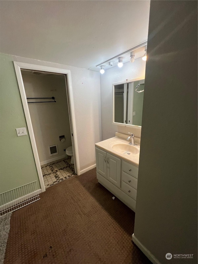 bathroom featuring vanity and toilet