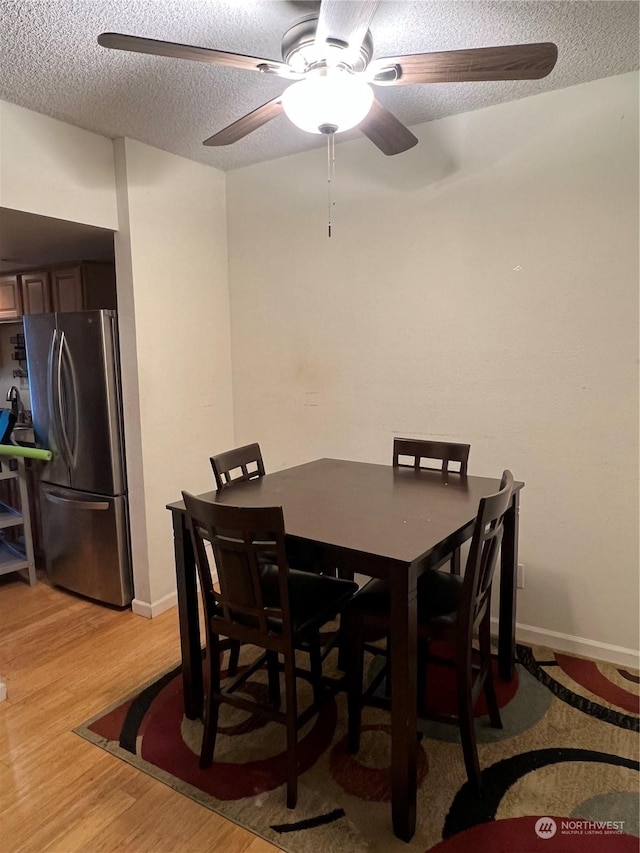 dining room featuring hardwood / wood-style floors and a textured ceiling