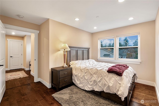 bedroom with dark hardwood / wood-style flooring