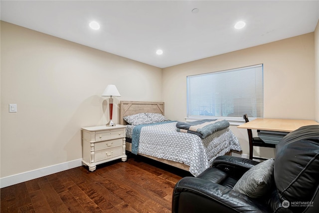 bedroom with dark hardwood / wood-style floors