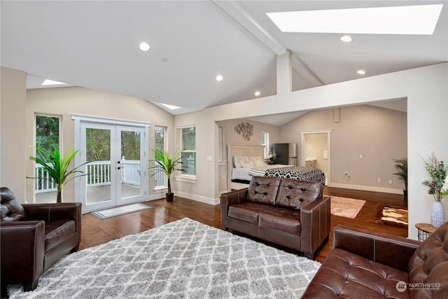 living room with vaulted ceiling with skylight, dark hardwood / wood-style flooring, and french doors