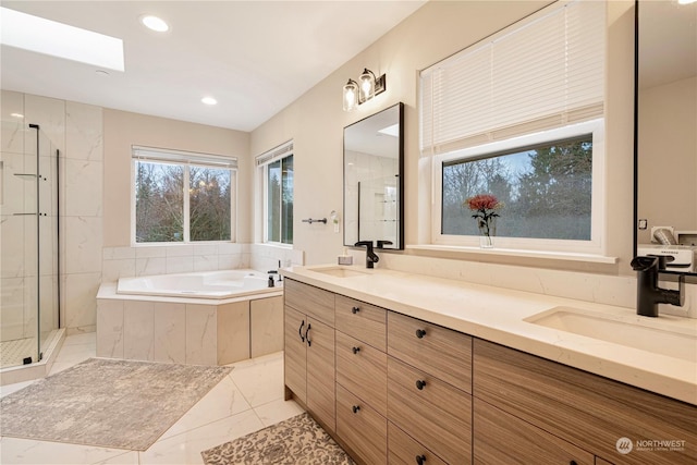 bathroom featuring vanity and independent shower and bath