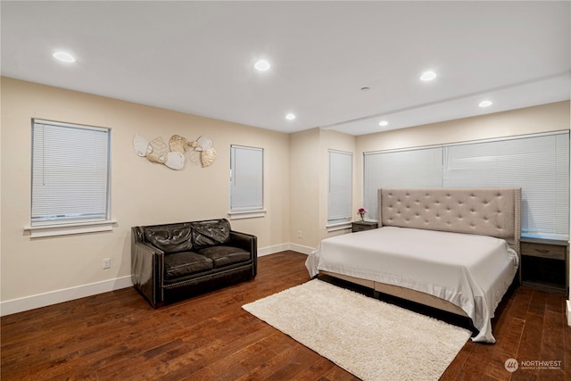 bedroom with dark hardwood / wood-style flooring