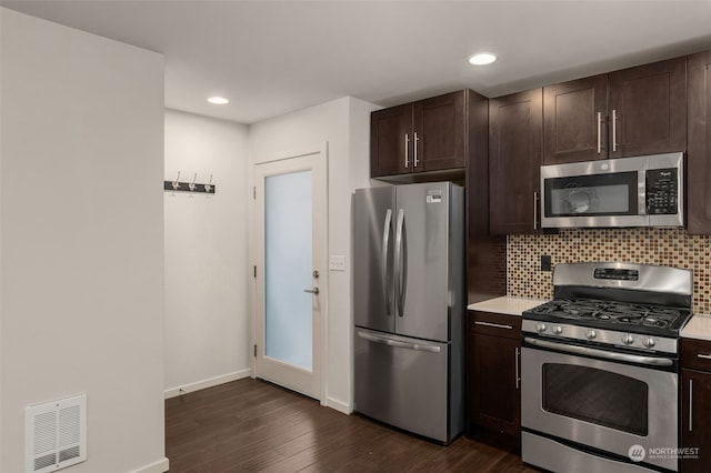 kitchen with dark hardwood / wood-style flooring, backsplash, stainless steel appliances, and dark brown cabinetry