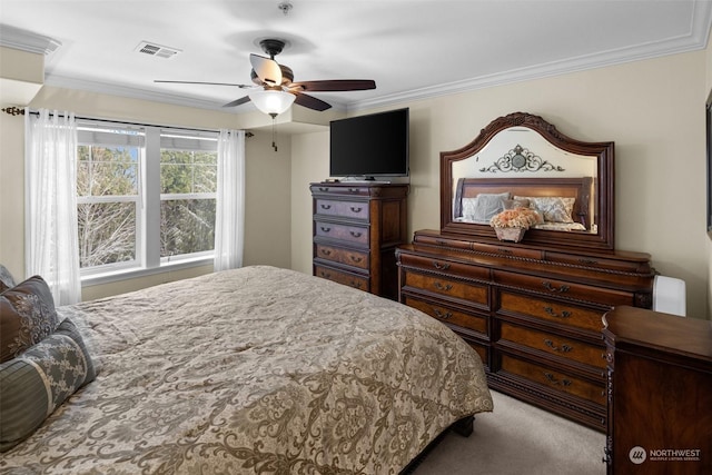 carpeted bedroom featuring crown molding and ceiling fan