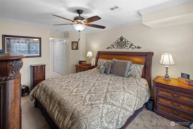 bedroom with carpet floors, ornamental molding, a closet, and ceiling fan