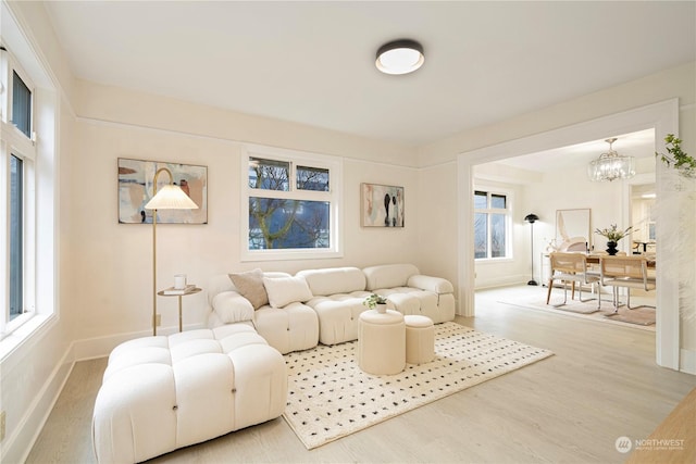 living room with hardwood / wood-style floors and a notable chandelier