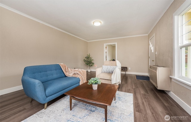 living area with crown molding, dark wood-type flooring, and baseboards