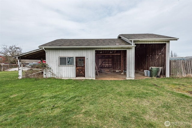 view of pole building featuring a yard and fence