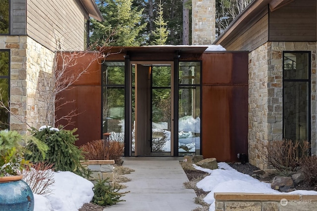 view of snow covered property entrance