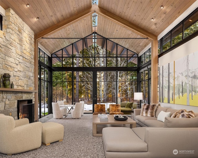 carpeted living room with beam ceiling, wood ceiling, a fireplace, and a wall of windows