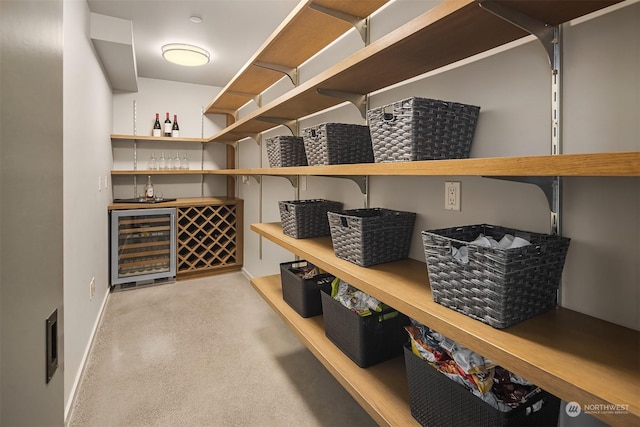 wine room with wine cooler and bar area