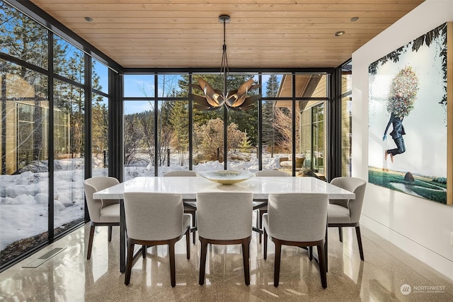 sunroom featuring an inviting chandelier, a wealth of natural light, and wood ceiling