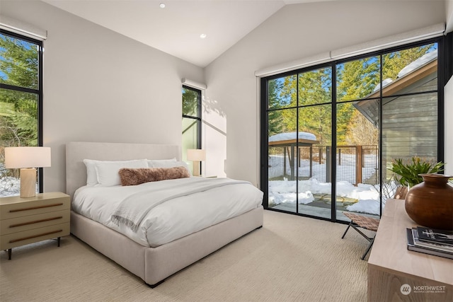 carpeted bedroom featuring access to exterior and vaulted ceiling