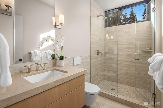 bathroom with vanity, toilet, and walk in shower