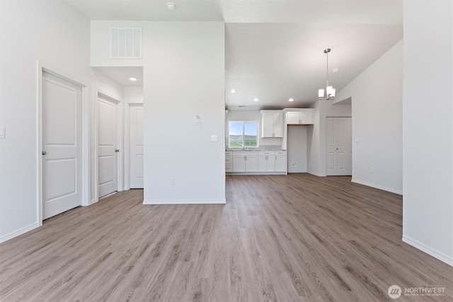 204 Cherry St, Mattawa, WA 99349 - unfurnished living room featuring light wood-type flooring and lofted ceiling