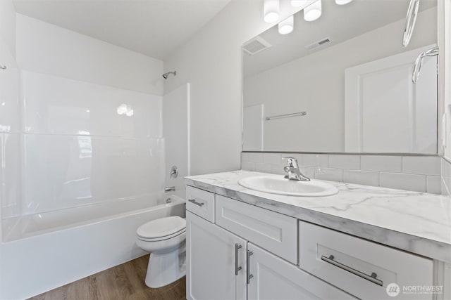 204 Cherry St, Mattawa, WA 99349 - full bath featuring vanity, wood finished floors, shower / bathtub combination, and tasteful backsplash
