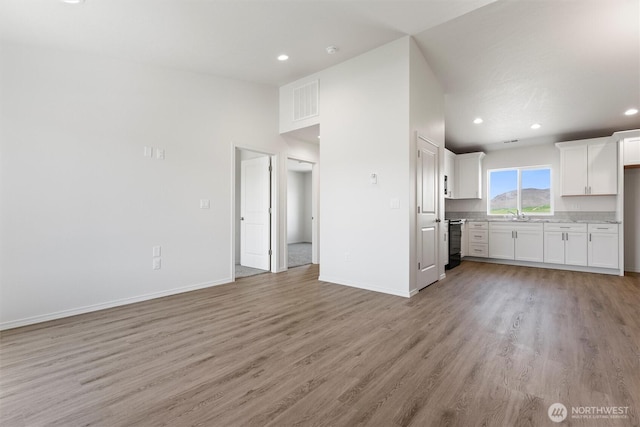 204 Cherry St, Mattawa, WA 99349 - unfurnished living room with light wood-type flooring and recessed lighting