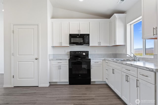 204 Cherry St, Mattawa, WA 99349 - kitchen featuring black appliances, lofted ceiling, white cabinets, and light wood-type flooring