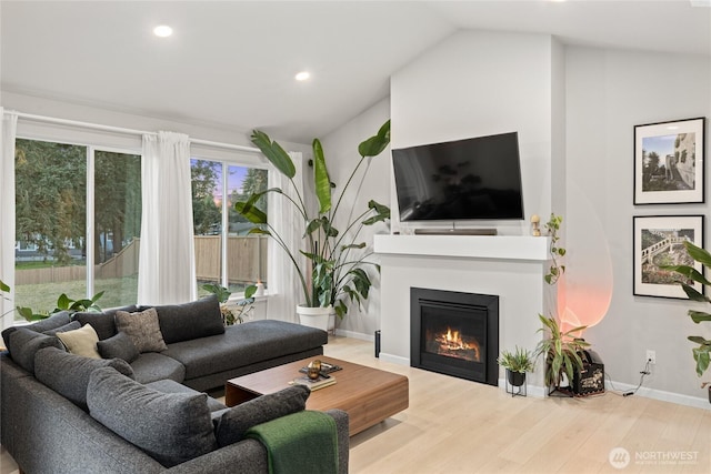 living room with lofted ceiling and hardwood / wood-style floors