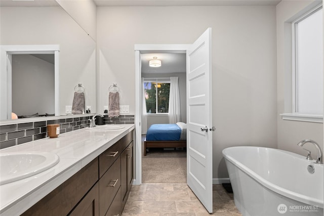 bathroom featuring vanity and a tub