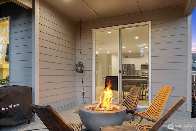 view of patio with an outdoor fire pit