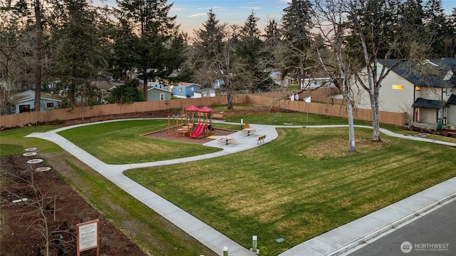 surrounding community with a playground and a yard