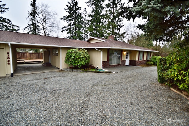 ranch-style home featuring a carport