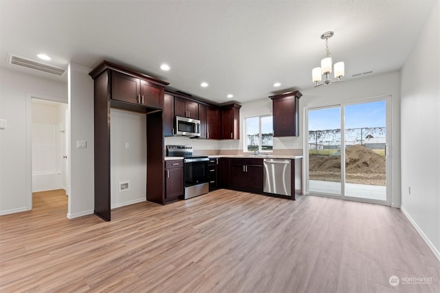 kitchen featuring a chandelier, pendant lighting, light hardwood / wood-style floors, stainless steel appliances, and dark brown cabinetry