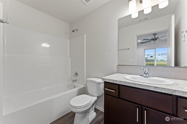 full bathroom with tub / shower combination, toilet, ceiling fan, wood-type flooring, and vanity