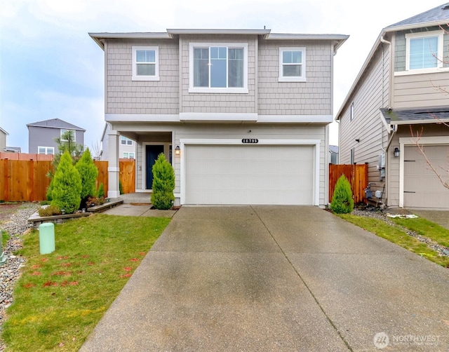 view of front of house featuring a garage, concrete driveway, fence, and a front lawn