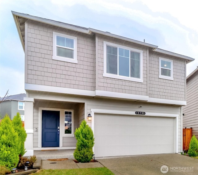 view of front of property featuring a garage and driveway