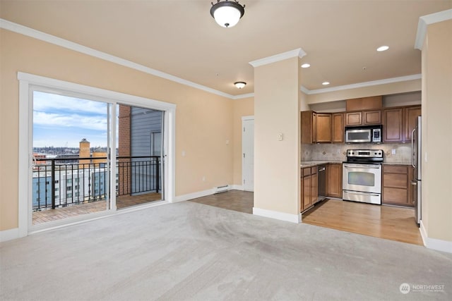 kitchen featuring crown molding, stainless steel appliances, decorative backsplash, a baseboard radiator, and light colored carpet