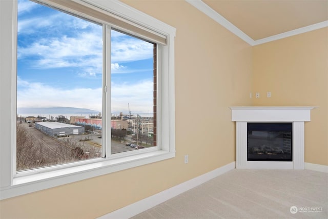 unfurnished living room featuring ornamental molding, plenty of natural light, and carpet floors