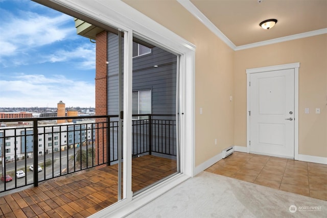 entryway featuring a baseboard radiator, ornamental molding, and tile patterned floors