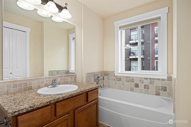 bathroom featuring vanity, a bath, and tasteful backsplash