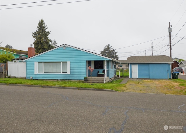 view of front of home with a storage shed