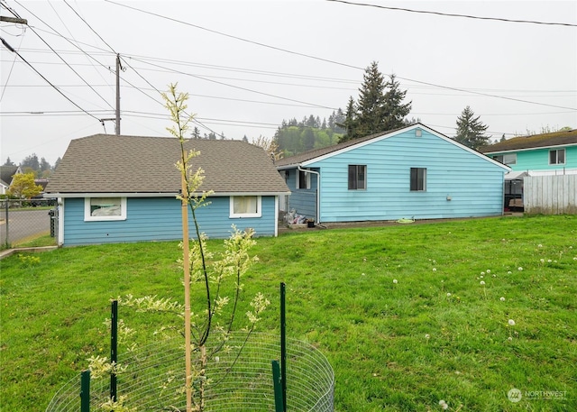 rear view of house featuring a lawn