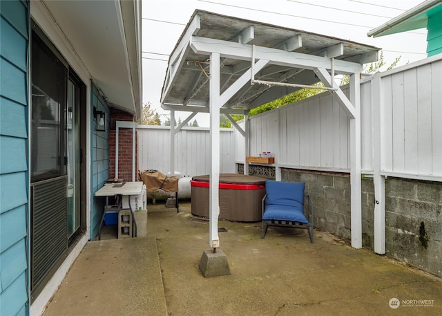 view of patio / terrace with a hot tub