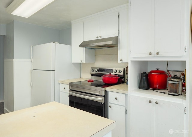 kitchen with white refrigerator, stainless steel electric range, and white cabinets