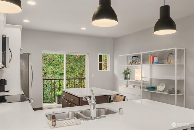 kitchen featuring pendant lighting, sink, and a kitchen island