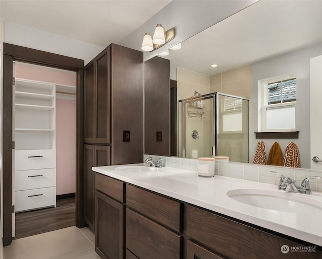 bathroom with vanity, tile patterned floors, and a shower with door