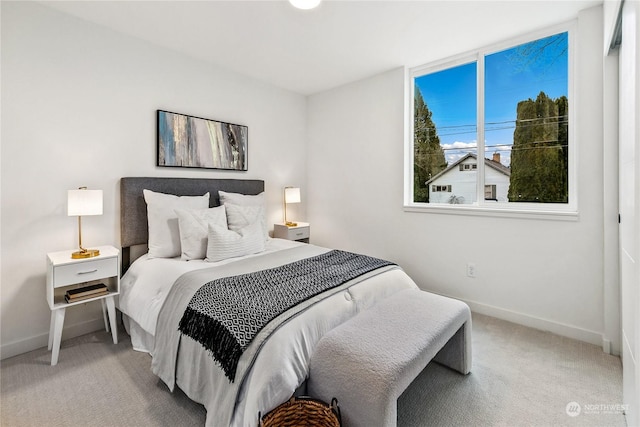 bedroom featuring light colored carpet