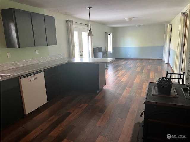 kitchen with dark wood-style flooring, open floor plan, a peninsula, decorative light fixtures, and white dishwasher