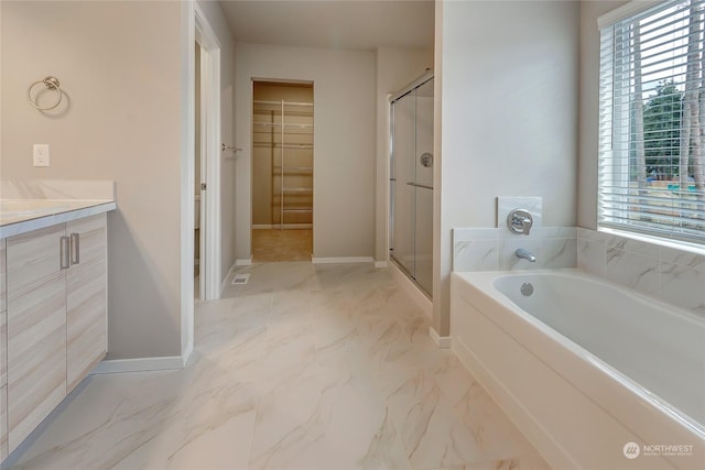 bathroom with vanity and independent shower and bath