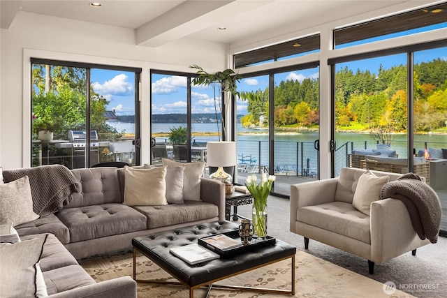 sunroom / solarium featuring a water view