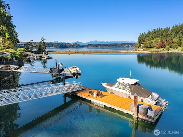 view of dock featuring a water and mountain view